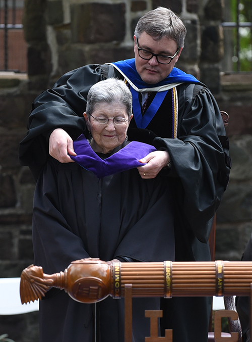 Provost Philip Sprung adjusts the hood on Jean R. (Alpert) Staiman '47 before President Trachte conferred an honorary degree to her.